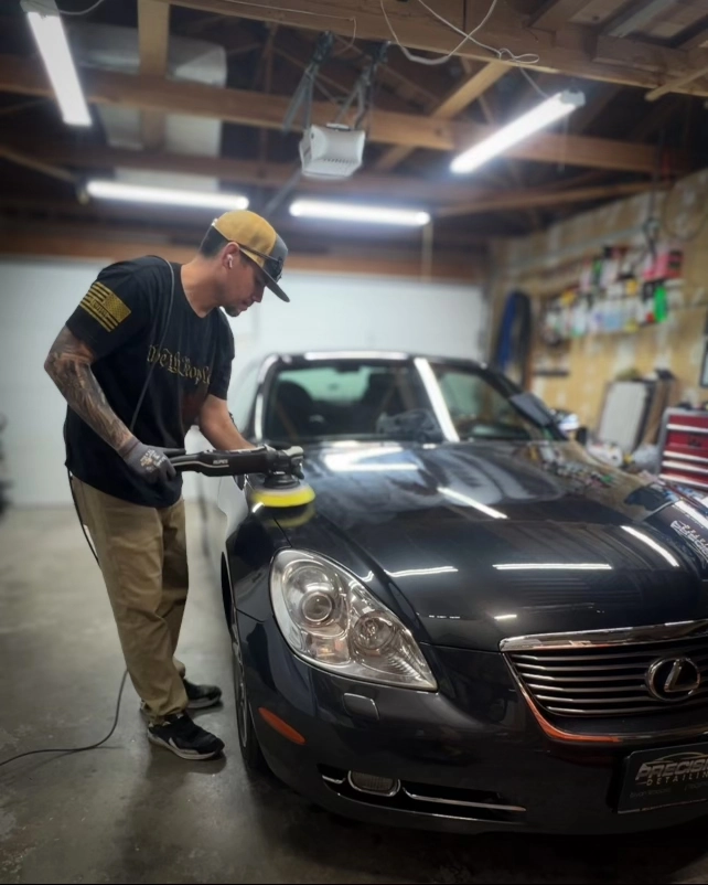 Precision Detailing owner Bryan Woolard waxing a Lexus